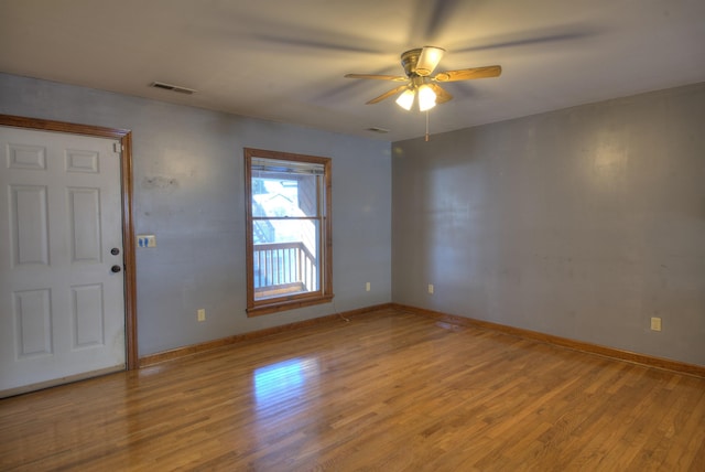 unfurnished room with hardwood / wood-style floors and ceiling fan