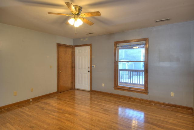 empty room featuring ceiling fan and light hardwood / wood-style floors