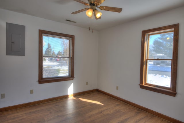 unfurnished room featuring dark wood-type flooring, electric panel, and ceiling fan