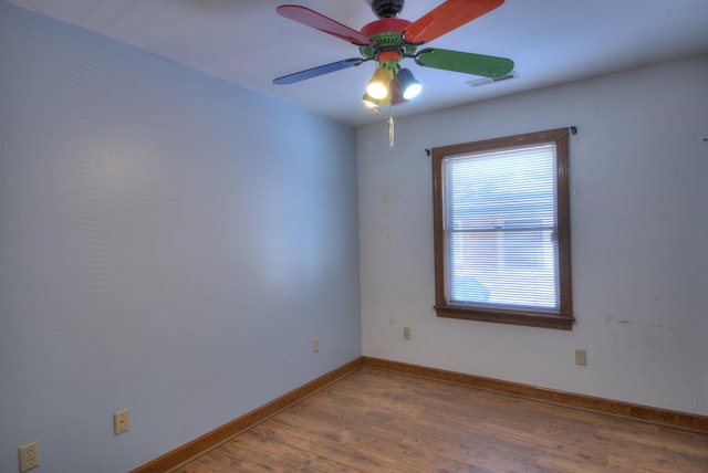 empty room featuring wood-type flooring and ceiling fan