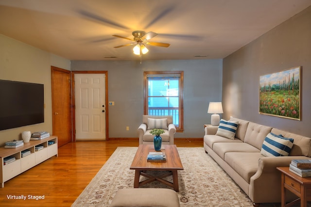 living room with ceiling fan and light hardwood / wood-style floors