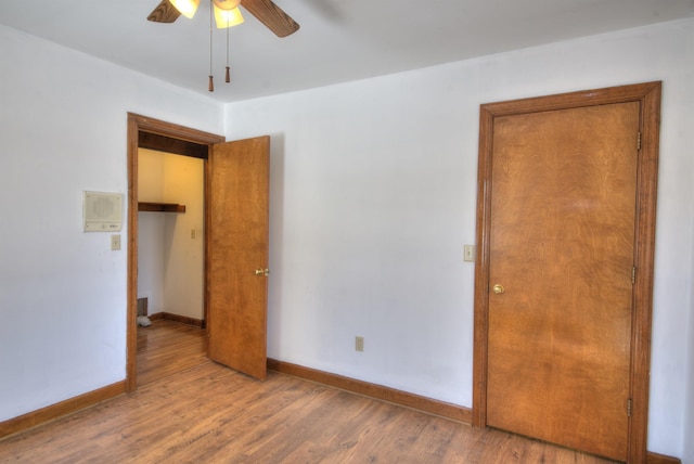 unfurnished bedroom featuring hardwood / wood-style flooring and ceiling fan