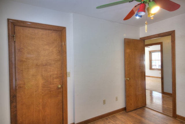 unfurnished bedroom with ceiling fan and light hardwood / wood-style floors