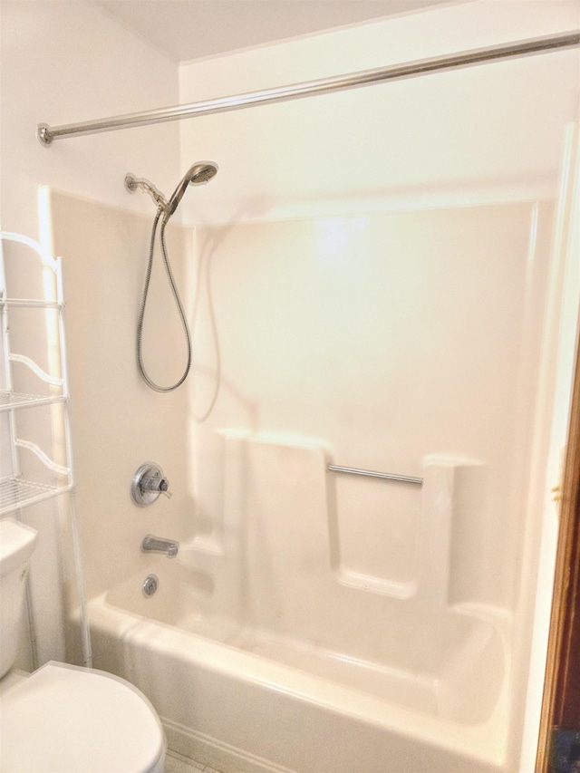 bathroom with shower / washtub combination and toilet