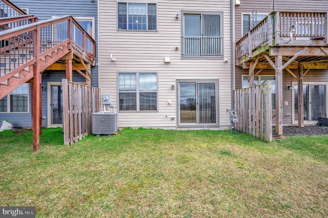 back of house featuring a yard, central AC unit, and a deck