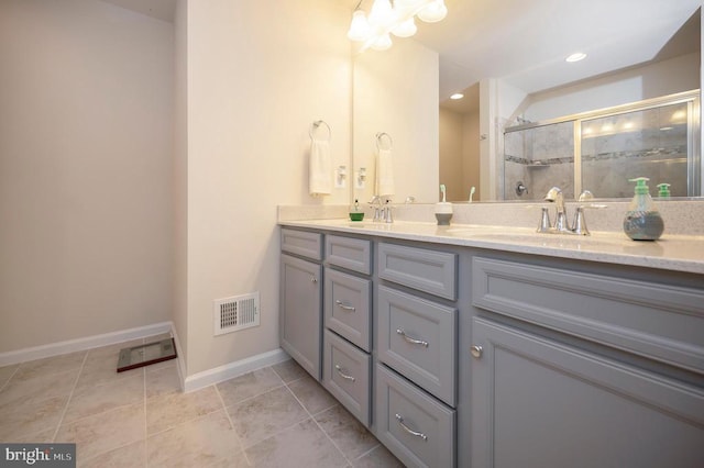 full bathroom featuring baseboards, visible vents, double vanity, a stall shower, and tile patterned floors