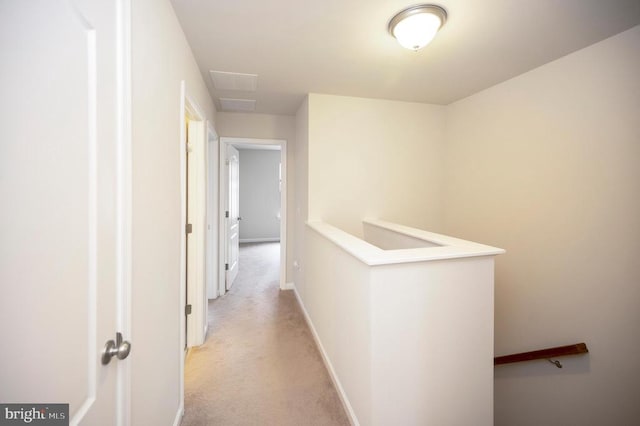 hall featuring an upstairs landing, baseboards, and light carpet