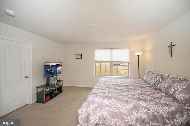 carpeted bedroom with baseboards