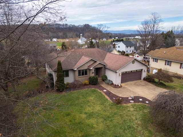 ranch-style home featuring a garage and a front lawn