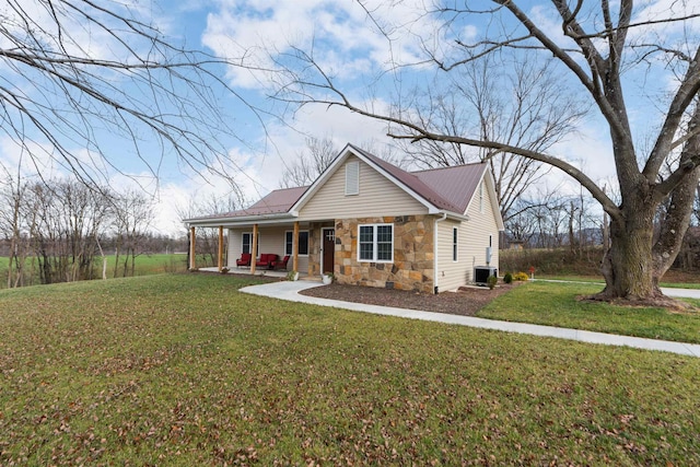 view of front of home with central AC, a porch, and a front lawn