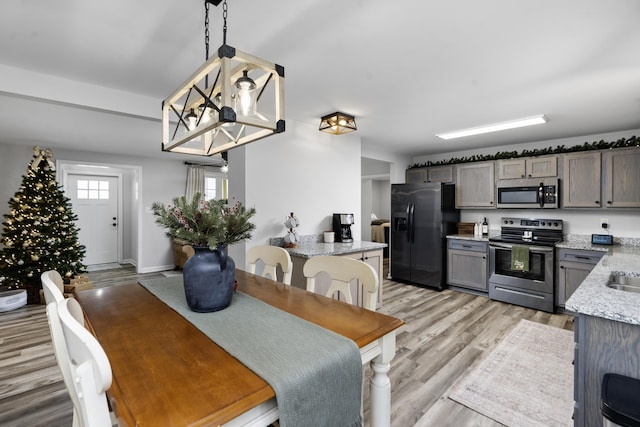 dining room with an inviting chandelier and light hardwood / wood-style floors