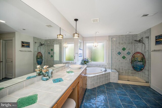 bathroom featuring tile patterned floors, vanity, and shower with separate bathtub