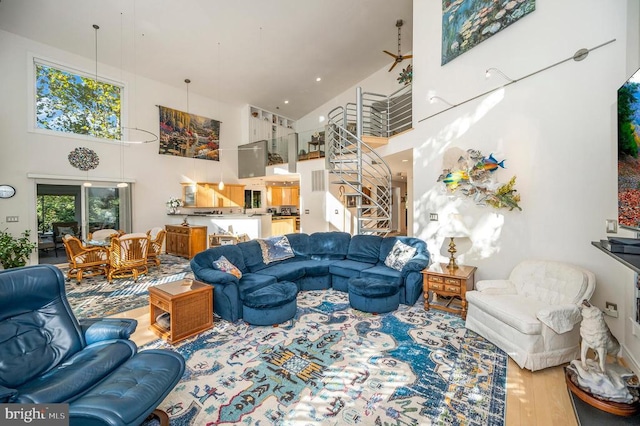 living room with hardwood / wood-style flooring and a high ceiling