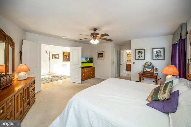 bedroom with light carpet, ensuite bath, and ceiling fan