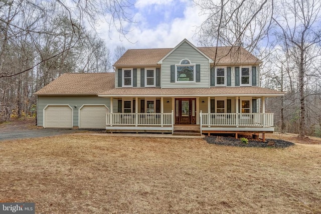 view of front of house featuring covered porch, aphalt driveway, roof with shingles, and an attached garage