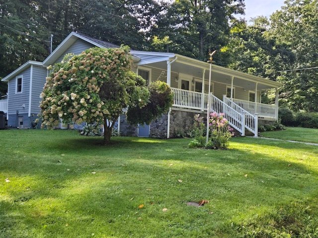 view of front of home with central AC, a front lawn, and a porch