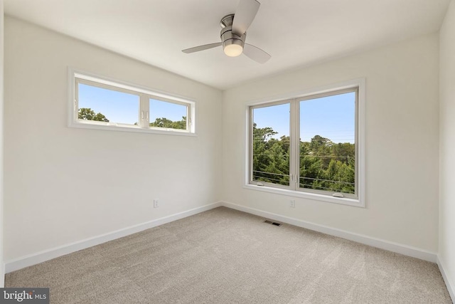 spare room featuring carpet and ceiling fan