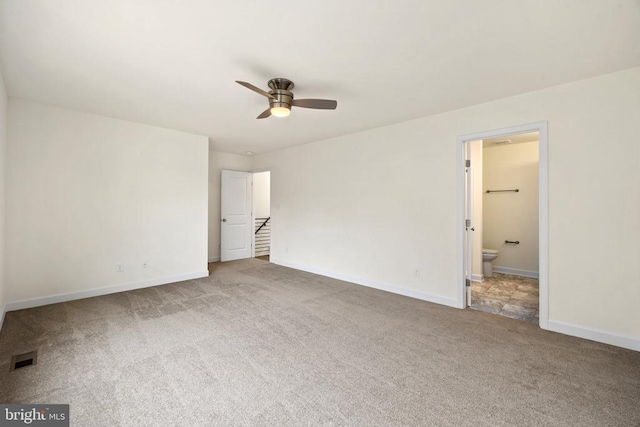 unfurnished bedroom featuring ensuite bathroom, carpet floors, and ceiling fan