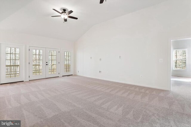 carpeted empty room with french doors, ceiling fan, and vaulted ceiling