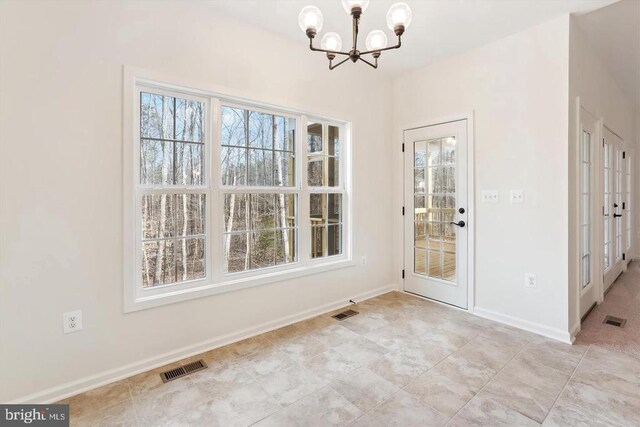 unfurnished dining area with a healthy amount of sunlight and a chandelier