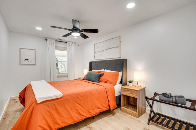 bedroom with light hardwood / wood-style flooring and ceiling fan