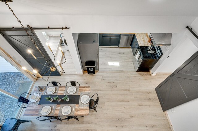 kitchen featuring stainless steel dishwasher and hardwood / wood-style floors