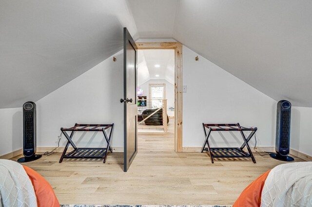 bedroom featuring lofted ceiling and hardwood / wood-style flooring