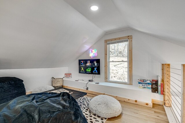 bedroom with vaulted ceiling and hardwood / wood-style floors