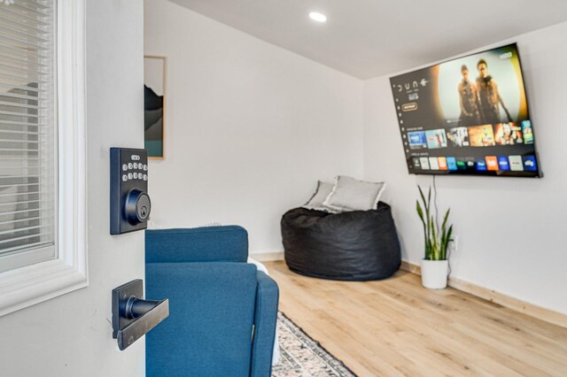 living area with hardwood / wood-style flooring