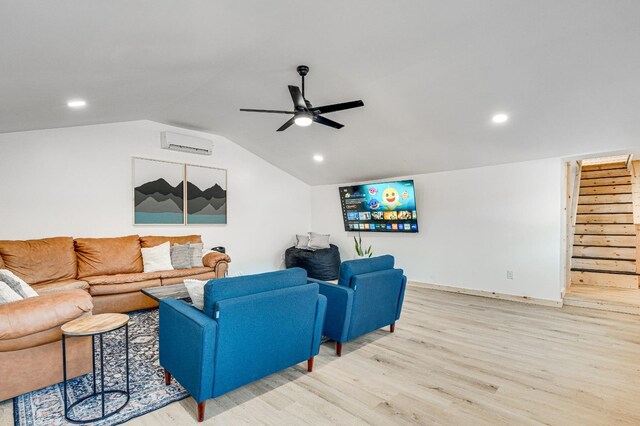 living room with vaulted ceiling, an AC wall unit, ceiling fan, and light wood-type flooring