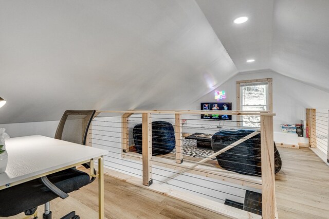 interior space with hardwood / wood-style flooring and lofted ceiling