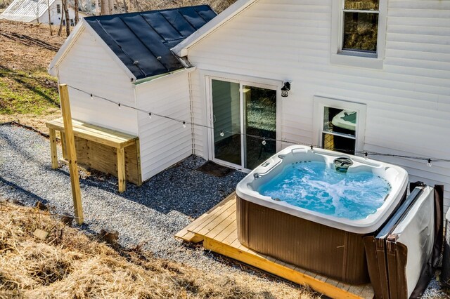 rear view of house with a hot tub