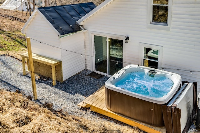 rear view of house with a hot tub