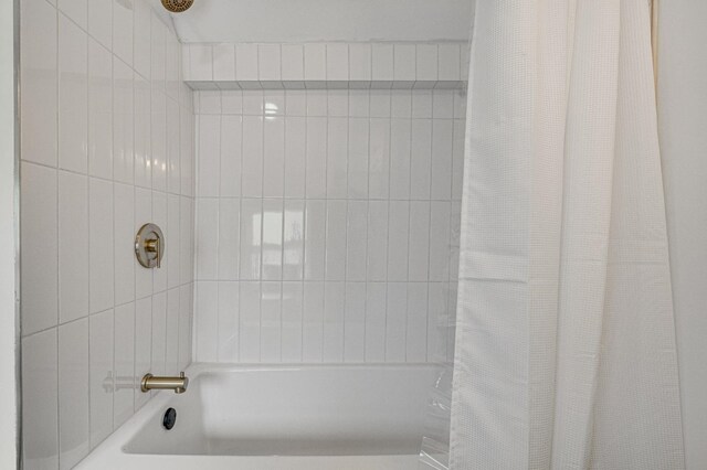 bathroom featuring shower / tub combo with curtain