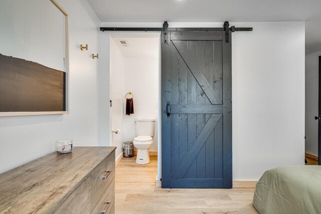 bathroom with wood-type flooring and toilet