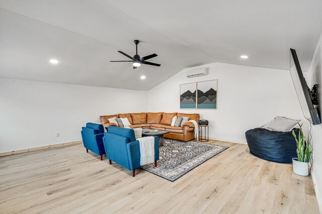 living room with vaulted ceiling, an AC wall unit, ceiling fan, and light hardwood / wood-style floors