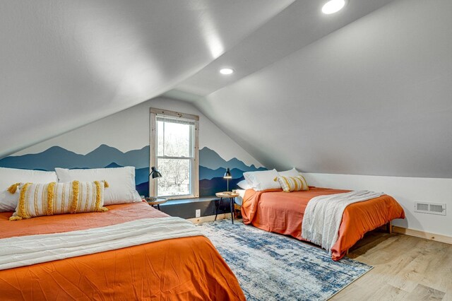 bedroom featuring vaulted ceiling and light hardwood / wood-style floors