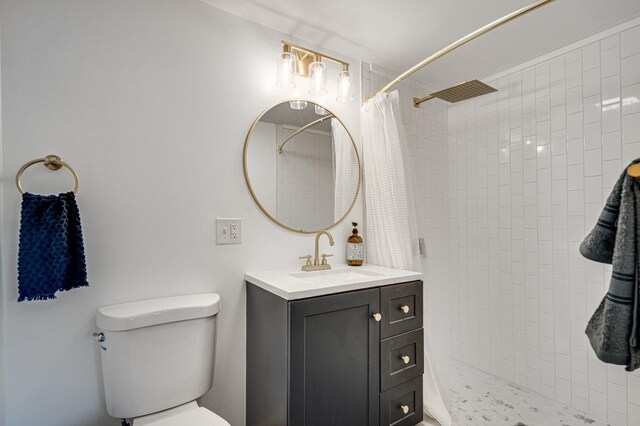 bathroom with a shower with curtain, vanity, and toilet