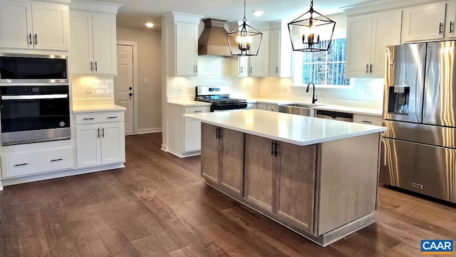 kitchen featuring custom exhaust hood, appliances with stainless steel finishes, dark wood-style flooring, and a sink