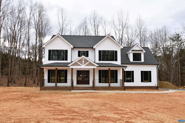 view of front of home with a front yard and a porch