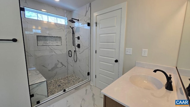 bathroom with marble finish floor, a marble finish shower, and vanity