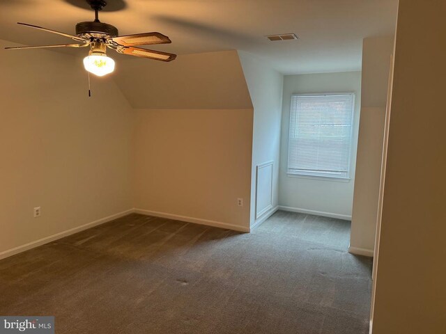 bonus room featuring ceiling fan, lofted ceiling, and dark carpet