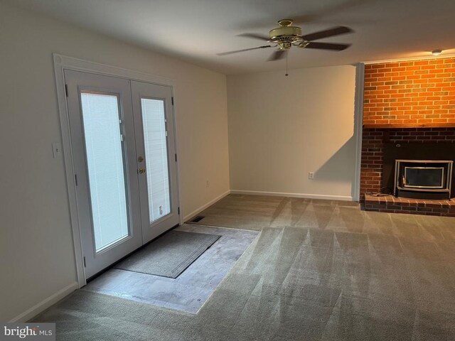 unfurnished living room featuring french doors, ceiling fan, and carpet