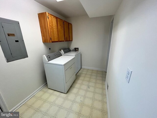 clothes washing area with cabinets, electric panel, and independent washer and dryer