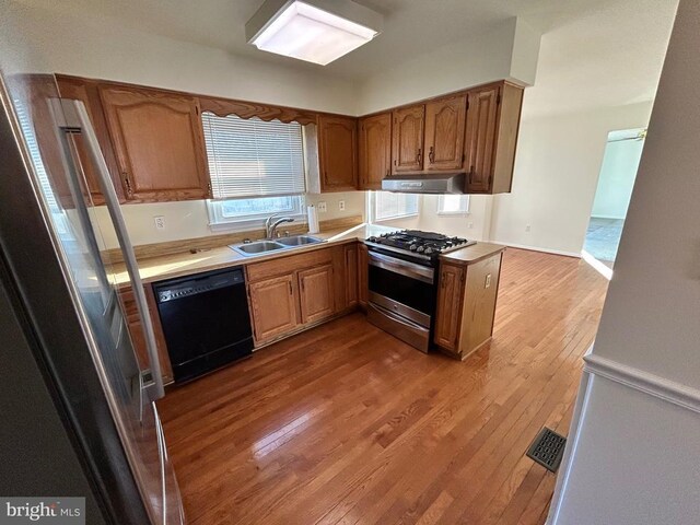 kitchen featuring dark hardwood / wood-style floors, stainless steel fridge with ice dispenser, a notable chandelier, and decorative light fixtures