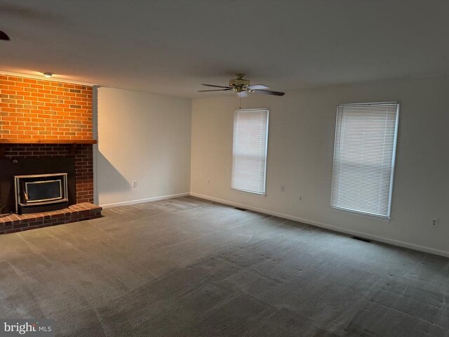 unfurnished living room featuring ceiling fan and carpet floors