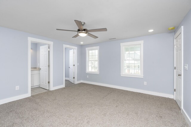 unfurnished bedroom with light carpet, recessed lighting, visible vents, and baseboards