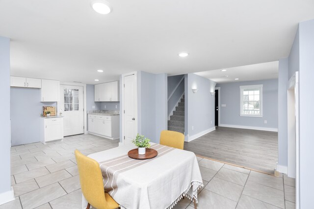 dining area with recessed lighting, light tile patterned floors, baseboards, and stairs