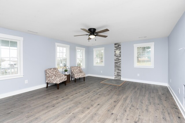 unfurnished room featuring ceiling fan, baseboards, and wood finished floors