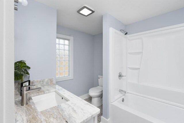 full bath with toilet, shower / tub combination, baseboards, and vanity